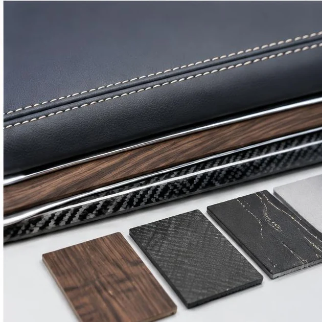 Stitched dashboard edge alongside wood and carbon finish samples