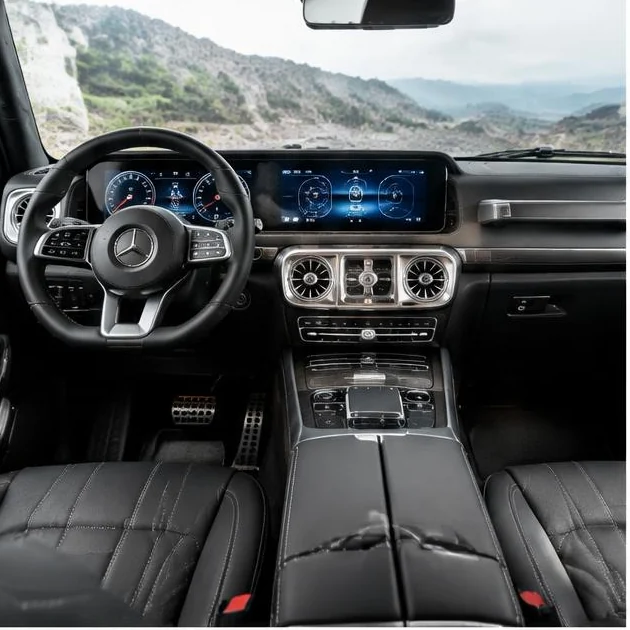 Angular off-road SUV cockpit with circular vents and digital displays — illustrative G-Class topic concept, not verified fitment