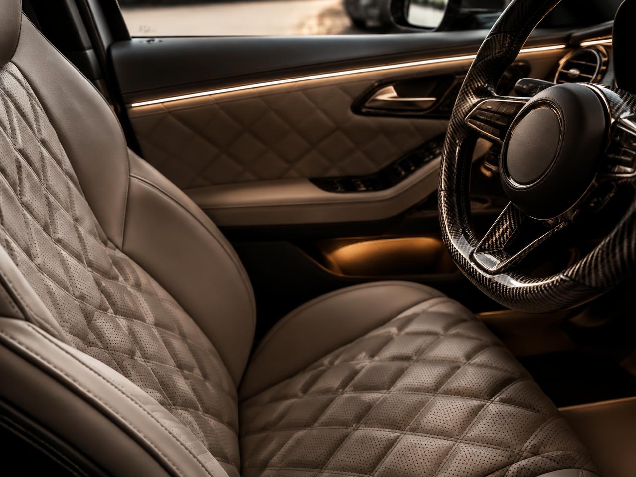 Quilted leather seat and carbon steering wheel — illustrative